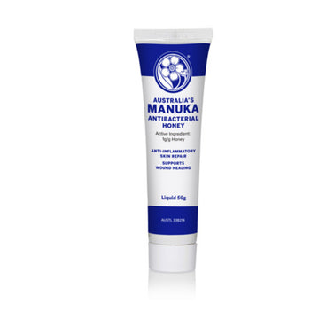 Blue and white 50g tube of antibacterial Australia's Manuka Honey for anit-inflammatory skin repair. The label describes the honey to support wound healing.