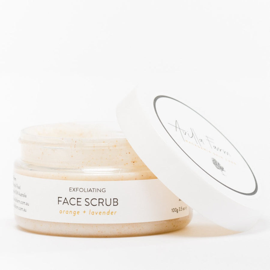 Exfoliating orange & lavendar face scrub with macadamia seed oil in 100g plastic container and lid off
