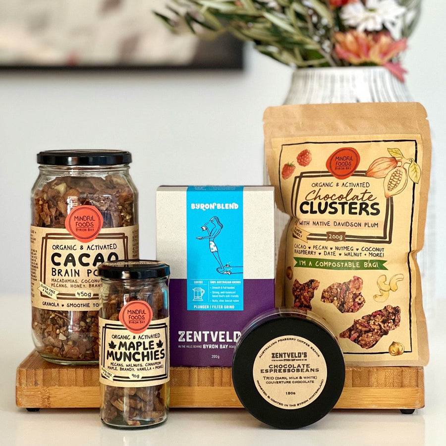 A gift hamper idea with organic Cacao Brain Food Granola in a 450g glass jar, Maple Munchies snacks, Zentvelds Byron Blend coffee, Chocolate Clusters with native Davidson plum in a compostable bag and Zendtveld's Chocolate Espressobeans