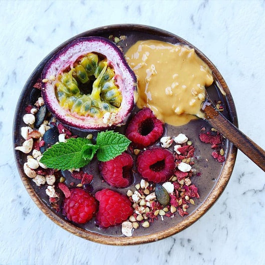 Cacao smoothie topped with organic & activated Eros Love & Vitality granola, also passionfruit , berries & mint