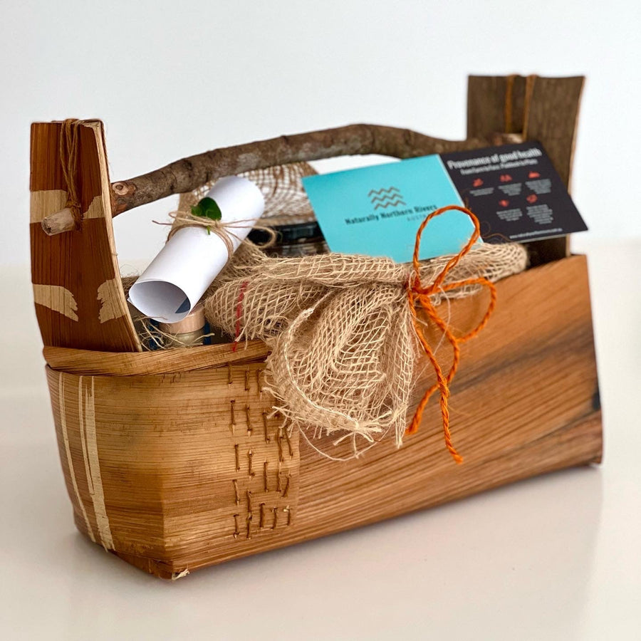 Handwoven Basket made from Bangalow Palm with a wooden handle.  Hessian wrapping around items in basket with a rolled up note and postcard with Naturally Northern Rivers logo.