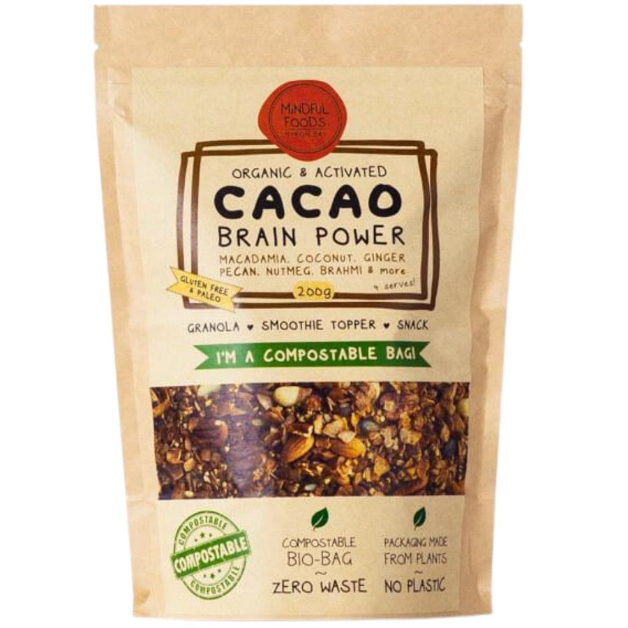 200g compostable bio-bag of cacao brain power granola with ingredients shown macadamia, coconut, ginger, pecan, nutmeg, brahmi & more.  The packaging is made from plant materials with no plastic used, highlights zero waste on packet